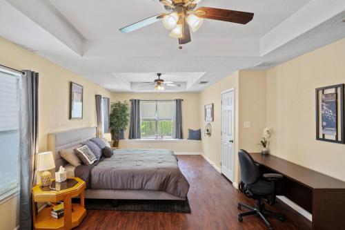 a bedroom with a bed and a ceiling fan at Bamboo Oasis-Relaxing Hot Tub-Family Time in San Antonio