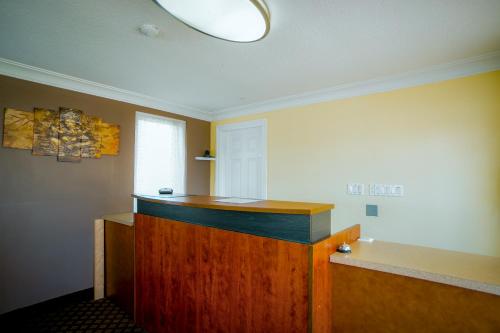 a room with a wooden counter and a window at Faulds Motel in Sarnia