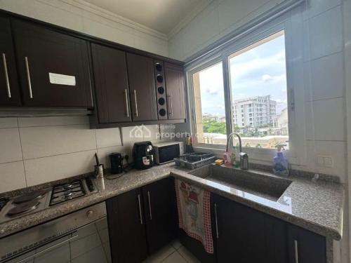 a kitchen with a sink and a stove and a window at AJAH LAGOS in Lekki