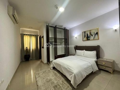 a bedroom with a large bed and a rug at AJAH LAGOS in Lekki