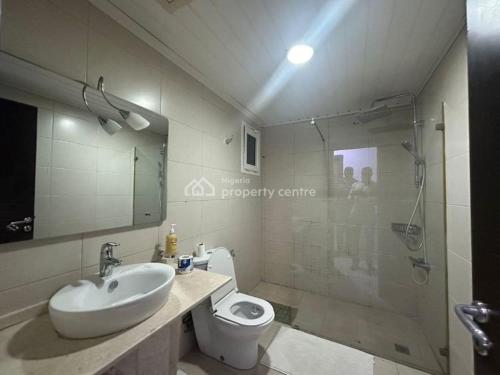 a bathroom with a sink and a toilet and a shower at AJAH LAGOS in Lekki