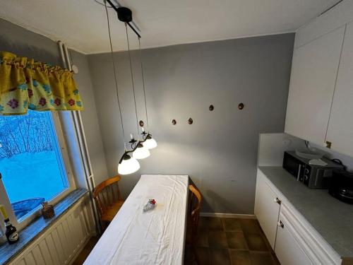 a small kitchen with a table and a window at Nyrenoverad design lägenhet in Ljungaverk