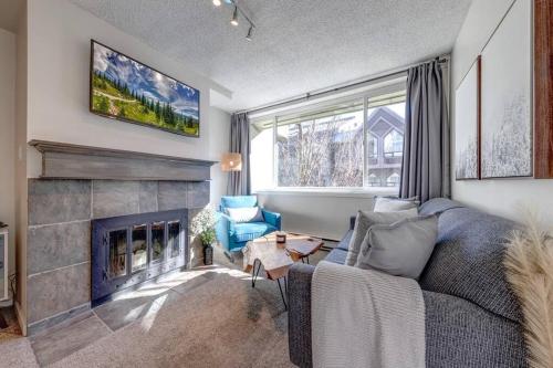 a living room with a couch and a fireplace at 1Bd Unit In the heart of Whistler Village in Whistler