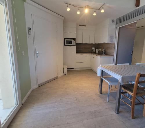 une cuisine et une salle à manger avec une table et des chaises dans l'établissement Beautiful T3 with balcony - near beach, à Fréjus