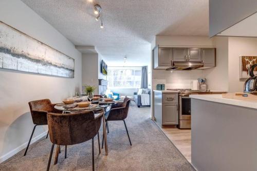 a kitchen and dining room with a table and chairs at 1Bd Unit In the heart of Whistler Village in Whistler