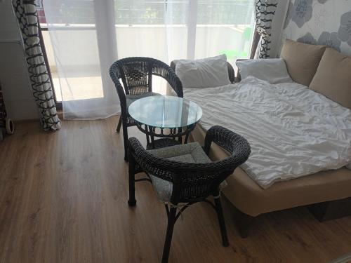 a living room with a table and chairs and a couch at Relaks w Marina Cape 88 in Aheloy