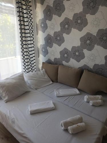 a bed with two white towels on top of it at Relaks w Marina Cape 88 in Aheloy