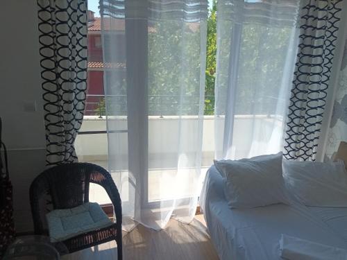 a bedroom with a bed and a large window at Relaks w Marina Cape 88 in Aheloy