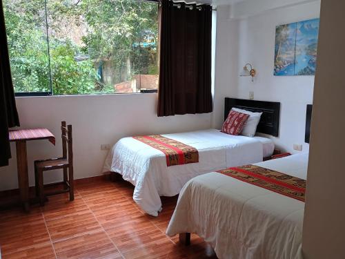 Cama ou camas em um quarto em Hostal killari Machupicchu