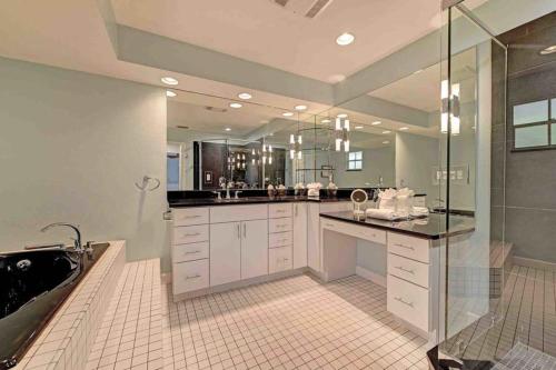 a bathroom with a shower and a sink and a tub at Surrounded By Sea Breezes - Anna Maria, FL in Anna Maria