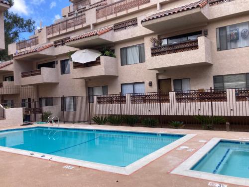 a swimming pool in front of a apartment building at Catalina's Got Cart Condo in Avalon