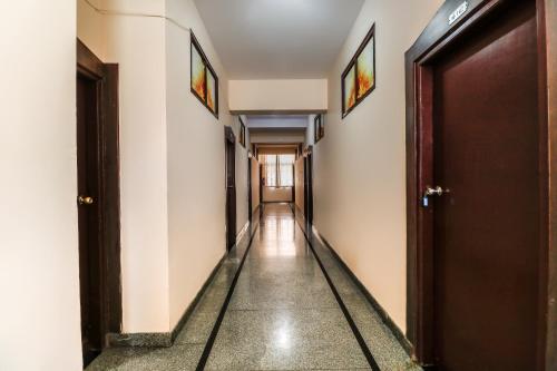 an empty hallway with two doors and a long corridor at Super OYO 40825 Jeevan Residency in Mysore