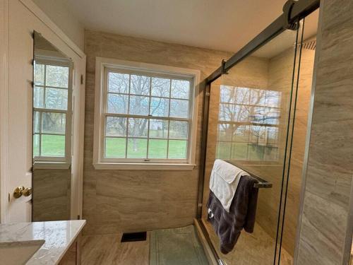 a bathroom with a shower and a window at Home away on Lake Ontario in Youngstown