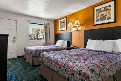 a hotel room with two beds and a window at Americas Best Value Inn - Lincoln in Lincoln