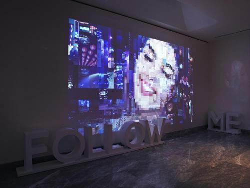a large screen with the word love on a wall at Naumi Hotel in Singapore