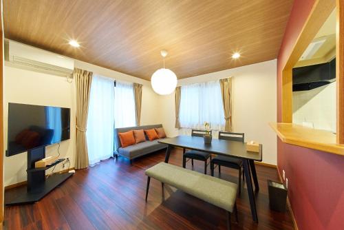 a living room with a table and a couch at The Prime TOKYO HANEDA in Tokyo