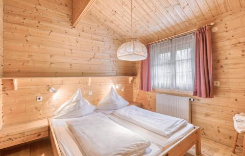 a bedroom with a bed in a wooden room at Ferienhaus Tauber 17 in Hayingen