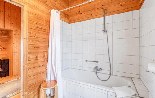 a bathroom with a white tub and a shower at Ferienhaus Tauber 82 in Hayingen