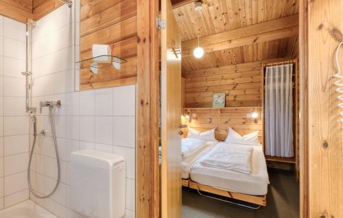 a bathroom with a bed and a shower in a room at Ferienhaus Neckar 70 in Hayingen