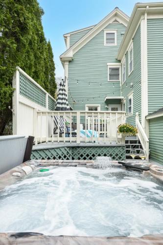 a house with a large pool in front of a house at The Front Porch Vacation Rentals in Bristol