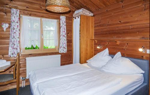 a bedroom with a white bed and a window at Ferienhaus Donau 89 in Hayingen
