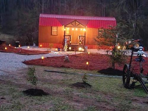 a house with lights in front of it at night at Lazy Bear Retreat by the Creek in Pickens