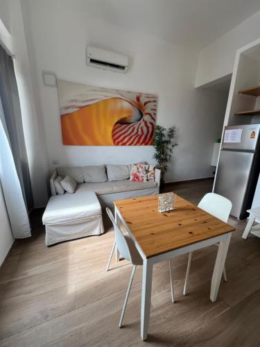 a living room with a table and a couch at punta beach bavaro hotel apartamentos in Punta Cana