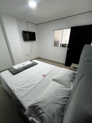 duże łóżko w pokoju z telewizorem w obiekcie Apartamento Escalini Pitalito w mieście Pitalito