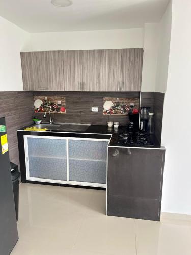 a kitchen with a sink and a stove at Apartamento Escalini Pitalito in Pitalito