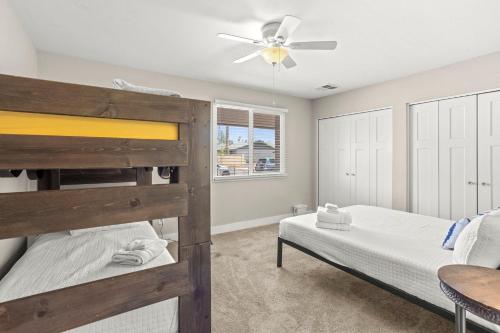 a bedroom with two bunk beds and a ceiling fan at Tempe Getaway - Pool - Putting Green in Tempe