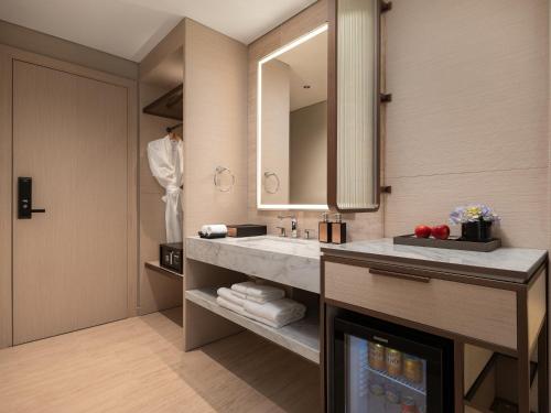 a bathroom with a sink and a mirror at CLASSYC Hotel in Hanoi
