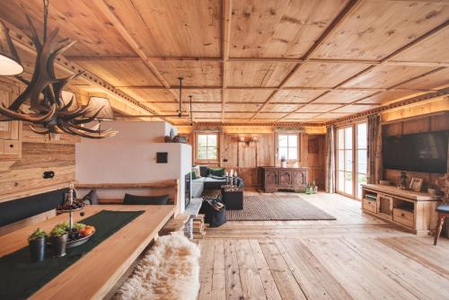 a large living room with wooden walls and ceilings at Sporer-Alm in Rohrberg