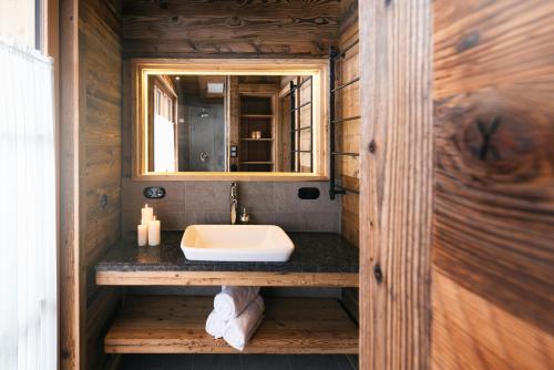 a bathroom with a sink and a mirror at Sporer-Alm in Rohrberg