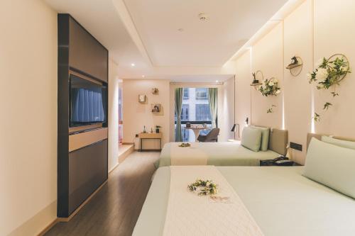 a hotel room with two beds and a television at Atour Hotel Shanghai Hongqiao International Exhibition Linkong Park in Shanghai