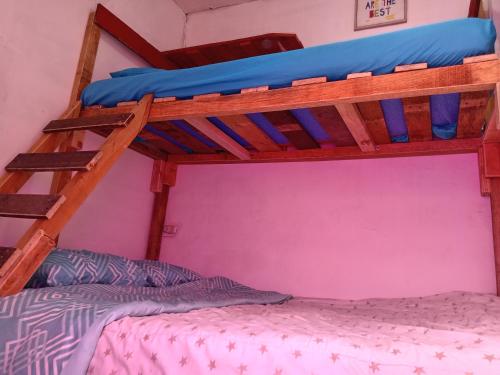 a bedroom with two bunk beds in a room at Karim Hostel in Guatemala