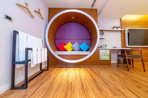 a room with a round window with colorful at Sunshine Palm B&B in Magong