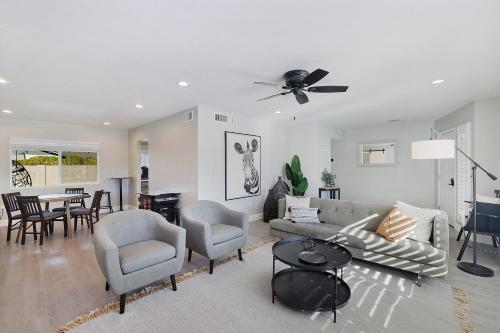 a living room with a couch and chairs and a table at Pegasus - Modern Tempe Getaway with Pool & Game Room in Tempe