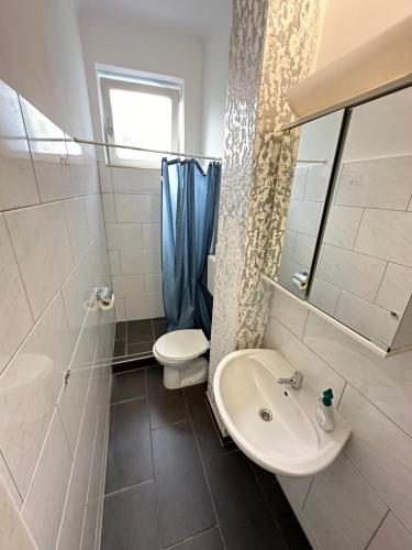 a bathroom with a sink and a toilet at City Apartment Hauptbahnhof in Graz