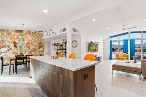 a kitchen and living room with a table and chairs at Desert Dream - Old Town Mid-Century Modern - Heated Pool in Scottsdale