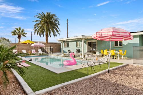 a swimming pool with a pink flamingo in a yard at Desert Dream - Old Town Mid-Century Modern - Heated Pool in Scottsdale