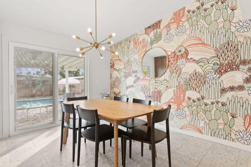 a dining room with a wooden table and chairs at Desert Dream - Old Town Mid-Century Modern - Heated Pool in Scottsdale