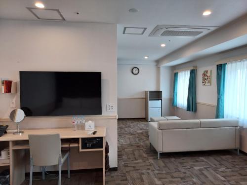 a living room with a couch and a flat screen tv at Toyoko Inn Changwon in Changwon