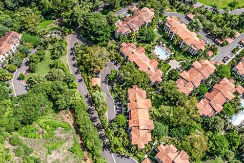 an overhead view of a group of houses with trees at Pacifico Townhouse 106 in Coco