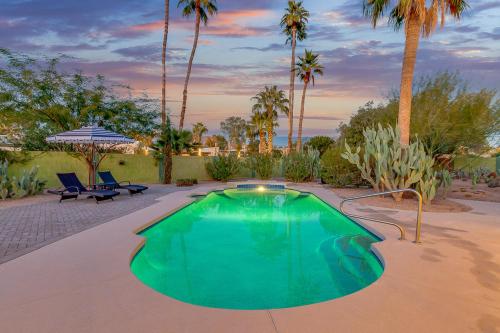 a swimming pool in a yard with palm trees at Olive Tree Retreat - Heated Pool, Patio & Privacy in Scottsdale