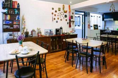 a dining room with two tables and chairs at Net House Cusco in Cusco