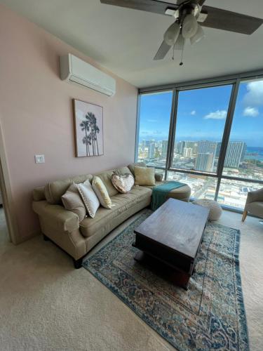 a living room with a couch and a table at Luxury Oasis Residence in Honolulu