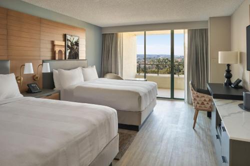a hotel room with two beds and a balcony at San Diego Marriott Mission Valley in San Diego