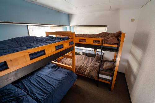 a room with two bunk beds in a house at Retopia AIZU磐梯町ゲストハウス 