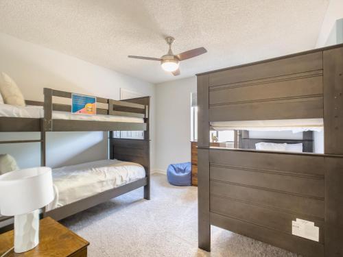 a bedroom with bunk beds and a ceiling fan at Glenbrook - Free Heated Pool - Hot Tub - Fire Pit in Fountain Hills