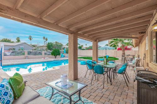 a patio with a table and chairs and a pool at Glenbrook - Free Heated Pool - Hot Tub - Fire Pit in Fountain Hills